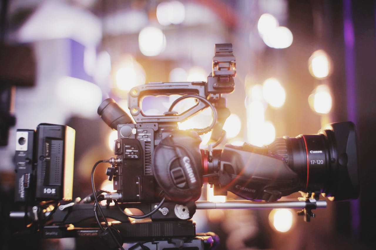 The Art of Drawing Readers In: Your attractive post title goes here Close-up of professional video camera setup for studio filming with blurred lights in the background.
